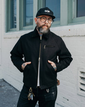 Man wearing black zip jacket